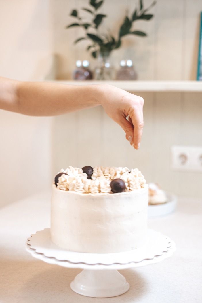 Anonymous confectioner sprinkling delicious cake